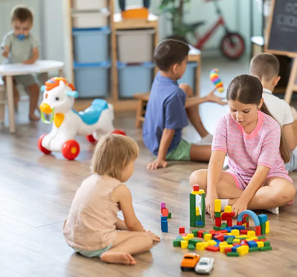 Kids playing with toy blocks in a freshly painted day care centre